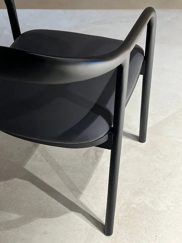 Black wooden chair with black fabric in a showroom detailed look