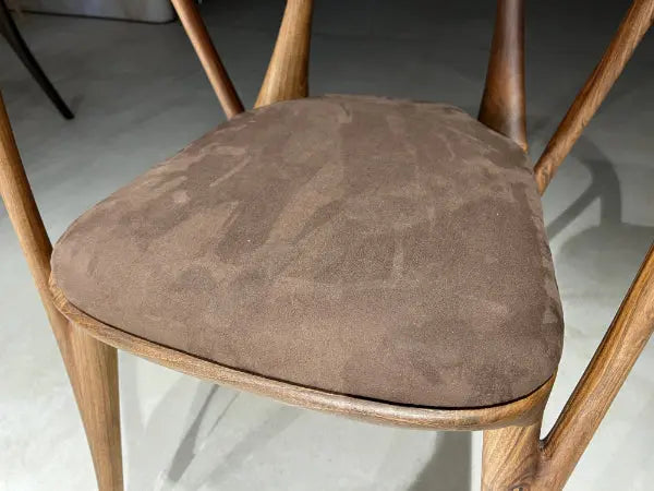 detailed look at upholstery of walnut chair