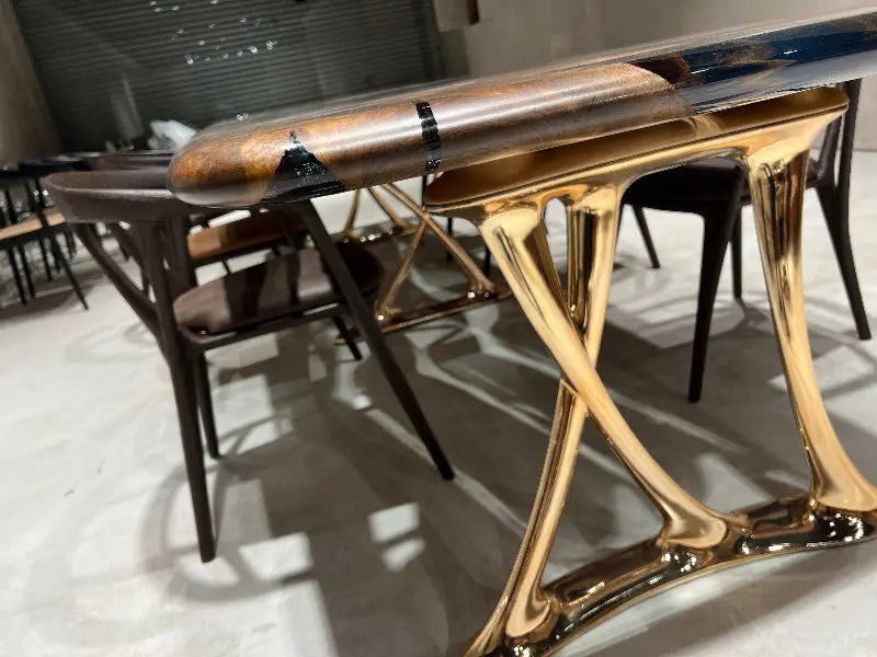 shiny rose gold aluminum legs of epoxy resin dining table