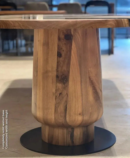 round resin dining table with wooden tulip base made of walnut