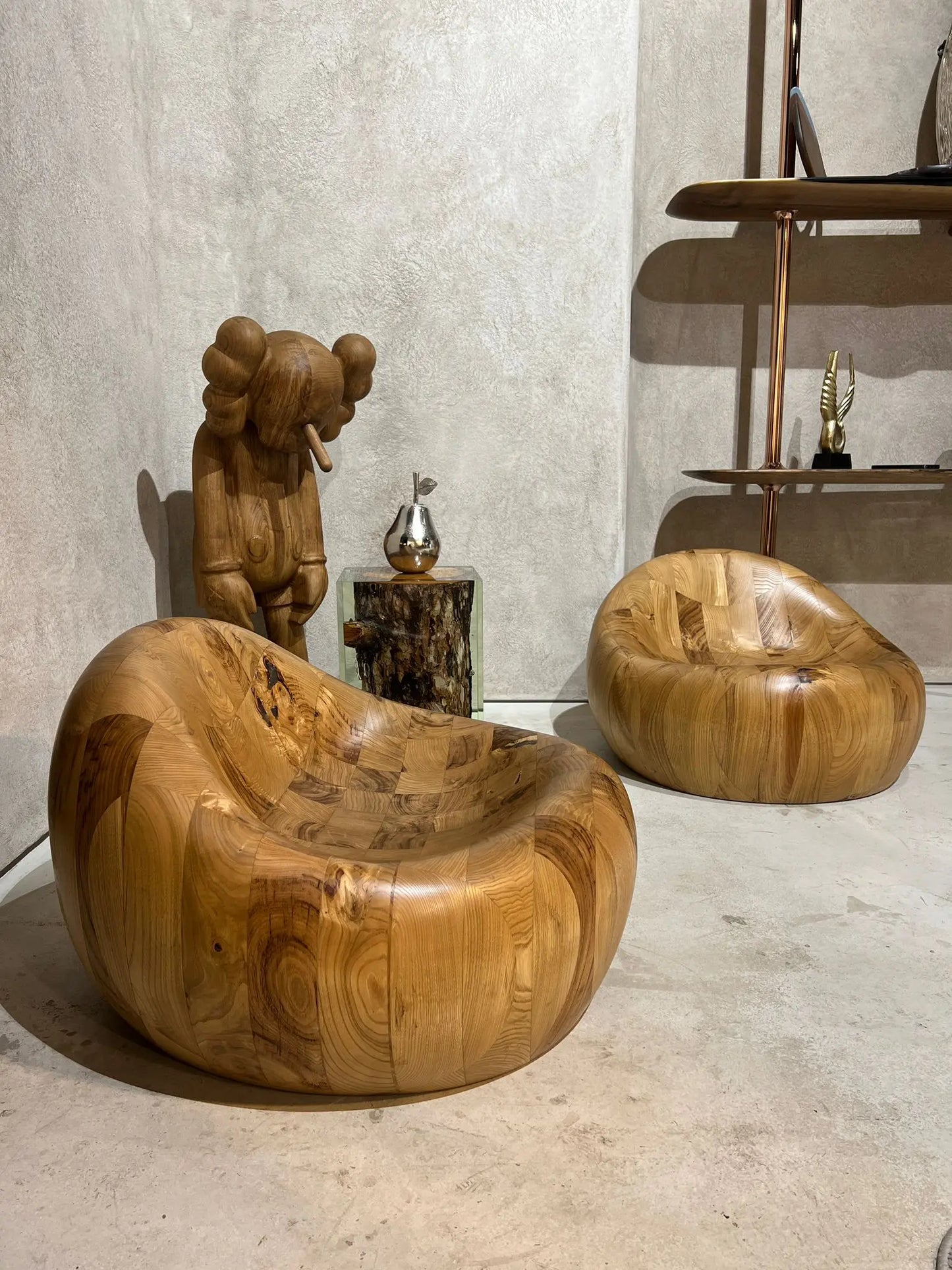 walnut wooden pod chair and kaws