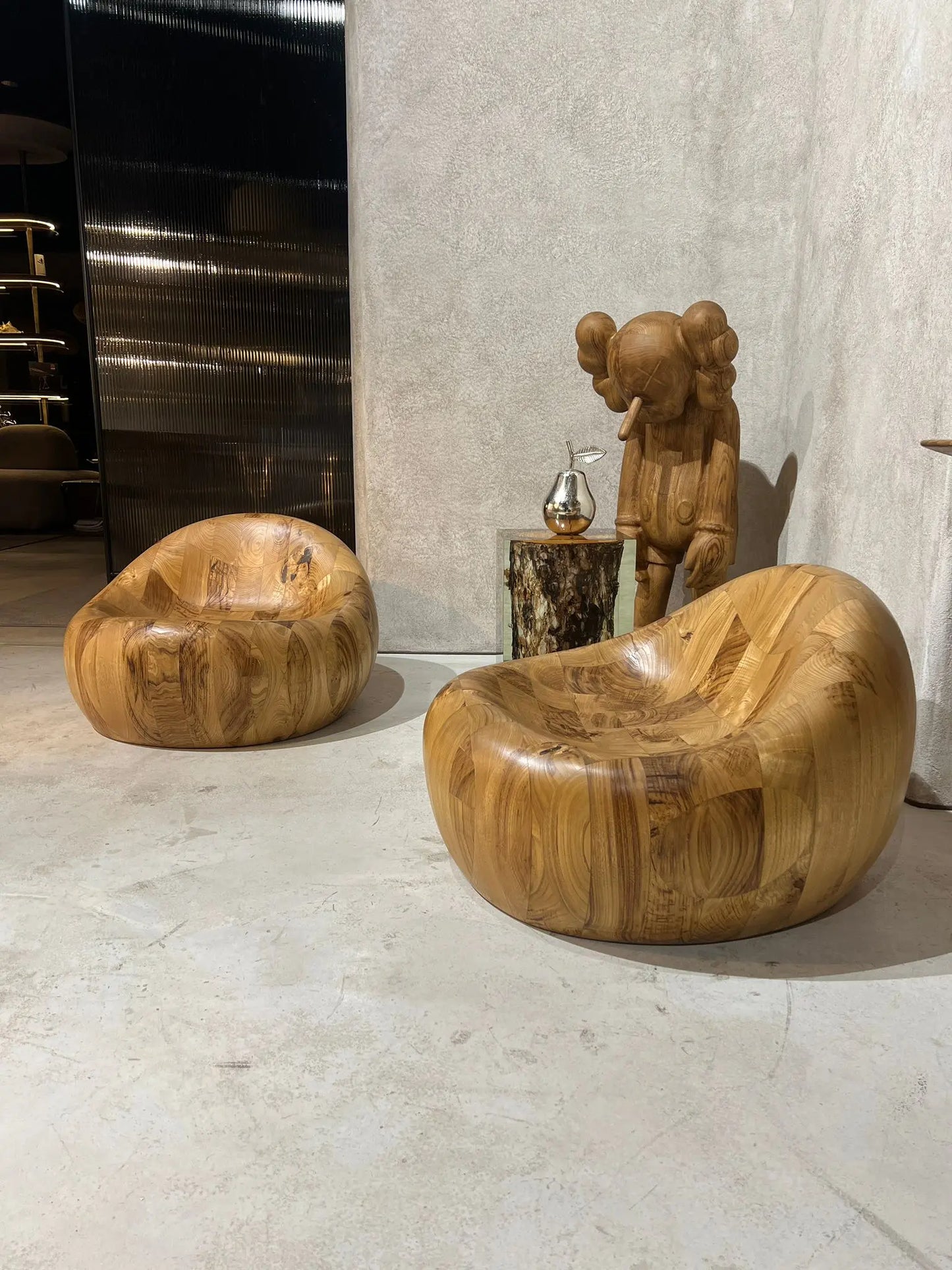 walnut wooden pod chair and kaws handcrafted decor