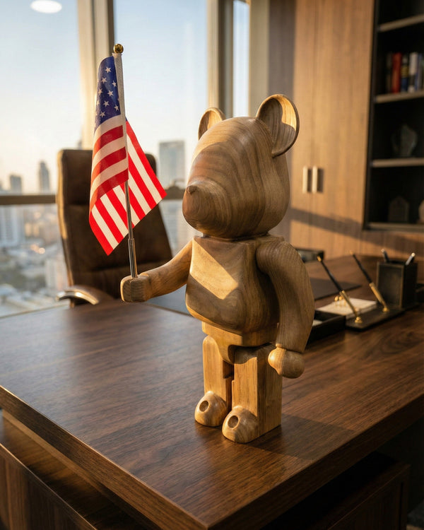 Wooden bear figurine holding an American flag on a desk with a cityscape view.