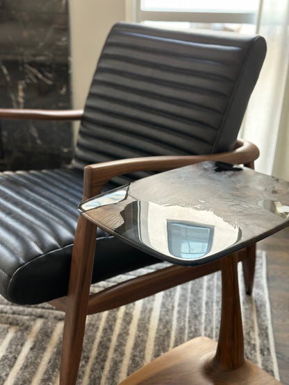 beautiful resin end table near to a black armchair.